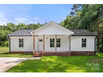 Charming single-story home with a welcoming front porch and well-maintained lawn at 1234 Goodnight Ln, Kannapolis, NC 28081