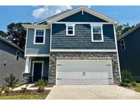Two-story home with blue siding, stone accents, and a two-car garage, set against a blue sky at 1418 31St Ne St, Conover, NC 28613