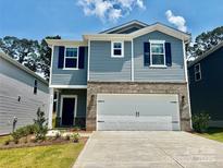 Charming two-story home with blue siding, brick accents, and a two-car garage at 1434 31St Ne St, Conover, NC 28613