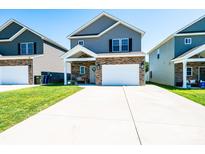 Charming two-story home with a stone facade, light gray siding and a spacious driveway at 2526 Snow Creek Ne Rd, Hickory, NC 28601