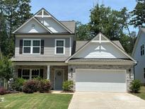 Charming two-story home with stone accents, attached garage, and beautifully landscaped front yard at 284 Old Harbor Dr, Mount Gilead, NC 27306