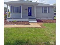 Charming single-story home with light gray siding, a cozy front porch, and a well-maintained lawn at 3412 1St Avenue Nw Cir, Hickory, NC 28601