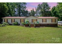 Charming single-story home with a well-manicured lawn and inviting front porch at 495 Brumley Rd, Mooresville, NC 28115