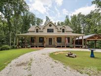 Inviting home showcasing a long covered porch and an oversized driveway at 820 King Rd, Clover, SC 29710