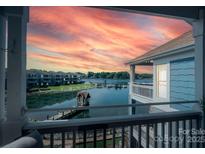 Stunning lake view from the balcony with a picturesque sunset and waterfront scenery at 1018 Southwest Sw Dr # 18, Davidson, NC 28036