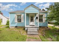 Charming light blue home with a welcoming front porch and well-maintained lawn at 1019 Richard St, Salisbury, NC 28144