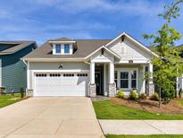 Charming single-Gathering home showcasing a well-maintained lawn and attached two-car garage at 1120 Idyllic Ln, Waxhaw, NC 28173