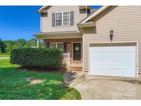 Charming two-story home with a brick entryway, manicured landscaping, and a convenient attached garage at 130 Ridge Bluff Rd, Mooresville, NC 28115