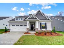 Charming single-story home with a two-car garage, stone accents, and manicured landscaping at 1425 Ardmore Dr # 247, Sherrills Ford, NC 28673