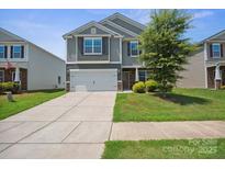 Two-story home showcasing a two-car garage, neutral siding, manicured lawn, and well-maintained landscaping at 154 King William Dr, Mooresville, NC 28115