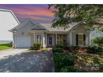 Inviting home featuring manicured landscaping, charming architecture, and an attached single-car garage at 168 Devon Forest Dr, Mooresville, NC 28115
