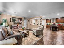 Cozy living room flows into kitchen featuring stylish furniture and decor with a rustic kitchen island at 200 Vista Pointe Dr, Stony Point, NC 28678