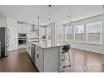 Bright kitchen features an island with stainless appliances and natural light at 235 Boxelder Rd, Clover, SC 29710