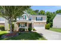 Charming two-story home featuring stone accents, green shutters, well-maintained landscaping, and a two-car garage at 3109 Buckleigh Dr, Charlotte, NC 28215