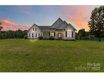 Charming single-Gathering home with a well-manicured lawn and inviting front porch at sunset at 3624 Ramsey Rd, Sharon, SC 29742