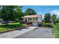 Charming two-story home featuring a well-manicured front lawn and a cozy outdoor seating area at 3651 16Th Ne St, Hickory, NC 28601