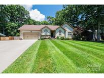 Charming single-story home with a well-manicured lawn and mature trees at 3889 Mattingly Dr, Hickory, NC 28602
