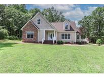Charming home with stone accents, a gabled roof, and a well-manicured lawn at 5890 Alley Rd, Catawba, NC 28609