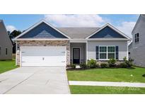 Charming single-story home featuring stone accents, a two-car garage, and well-maintained landscaping at 7106 Jerimoth Dr, Charlotte, NC 28215