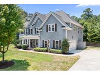 Charming two-story home with gray siding, brown shutters, and a well-manicured front yard at 738 Kemp Rd, Mooresville, NC 28117