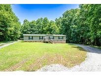 Charming single-story home with a covered front porch and a well-maintained lawn surrounded by mature trees at 812 Acclaim Dr, York, SC 29745