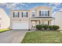 Two-story home with neutral siding, black shutters, a well-manicured lawn, and an attached two-car garage at 9822 Bayview Pkwy, Charlotte, NC 28216