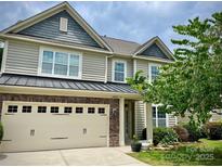 Charming two-story home featuring a two-car garage and a beautifully landscaped front yard at 10009 Community House Rd, Charlotte, NC 28277