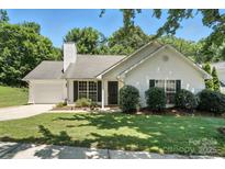 Charming single-story home with well-maintained lawn, trimmed bushes, and black shutters at 14658 Laura Michelle Rd, Huntersville, NC 28078