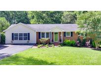 Charming single-story home features a well-manicured lawn and a mix of brick and siding exterior at 1498 Legion Rd, Fort Mill, SC 29715