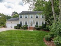 Charming two-story home with a manicured lawn, complemented by a lush green landscape and an attached two car garage at 2410 Monticello Dr, Gastonia, NC 28056