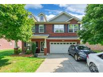 Charming two-story brick home featuring a well-manicured lawn and an attached two-car garage at 2476 Glyncastle Way, Gastonia, NC 28056