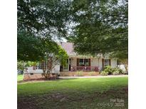Charming single-story home featuring a welcoming front porch and lush green lawn at 2511 Old Pond Dr, Lincolnton, NC 28092