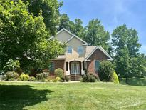 Charming two-story home with landscaped yard and brick accents, surrounded by mature trees at 322 Oakview Dr, Salisbury, NC 28146
