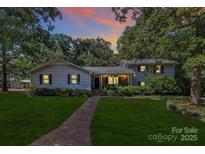 Charming two-story home with a well-manicured lawn and inviting walkway leading to the front door at 3311 Camden Rd, Marshville, NC 28103