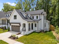 Charming two-story modern farmhouse with white siding, black trim, and a landscaped yard at 3953 Plainview Rd, Charlotte, NC 28208
