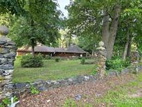 Unique home with stone wall and ballustrades, wooded surrounding, and unusual roofline at 404 Long Shoals Rd, Bessemer City, NC 28016