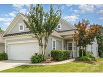 Charming home with gray siding, manicured lawn, two-car garage, and inviting front entryway at 4079 Murray St, Fort Mill, SC 29707