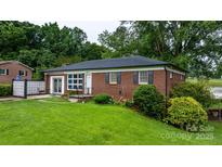Charming brick home featuring a well-manicured front lawn and decorative shutters at 5083 Fleetwood Dr, Hickory, NC 28602