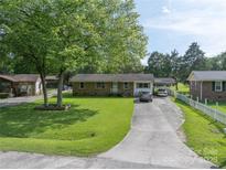 Charming single-story brick home with a well-manicured lawn and a spacious driveway at 517 Fieldcrest Dr, Chester, SC 29706