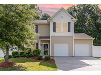 Charming two-story home featuring a two-car garage, well-maintained lawn and manicured landscaping at 523 Smokehouse Ln, Albemarle, NC 28001