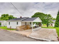 Charming single-story home with white siding, a covered parking area, and a handicap accessible ramp at 814 Grace St, Kings Mountain, NC 28086