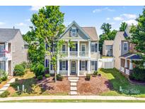 Charming two-story home with a welcoming front porch and blue shutters at 10509 Serape Rd, Charlotte, NC 28277