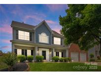 Charming two-story home featuring a manicured lawn and a welcoming front porch at 112 Steeplechase Ave, Mooresville, NC 28117