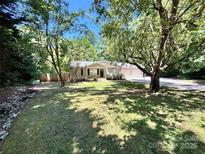 Charming home with a well-maintained lawn and mature trees, offering shade and curb appeal at 124 Julius Ln, Mooresville, NC 28117