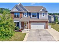 Charming two-story home showcasing a well-maintained lawn, a two-car garage, and inviting curb appeal at 1324 Mona Vale Dr, Huntersville, NC 28078