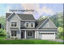 Charming two-story home boasts a classic design, complemented by a two-car garage and well-manicured lawn at 139 Eve Ash Ln # 35, Mooresville, NC 28115