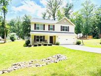 Inviting two-story home features a well-manicured lawn, two-car garage, and a basketball hoop on the driveway at 1528 Magnolia Dr # 8, Lancaster, SC 29720