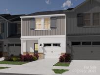 Charming townhome featuring gray vertical siding, white horizontal siding, and a one-car garage at 222 Tiger Lily Dr, Fort Mill, SC 29708