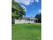 Charming single-story home with a well-manicured lawn and covered front porch at 28518 Flint Ridge Rd, Albemarle, NC 28001
