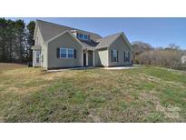 Charming home with muted green siding, dark shutters, and well-manicured lawn at 4017 Avis Way, Monroe, NC 28110